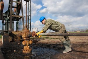 inspector working on an oil pump