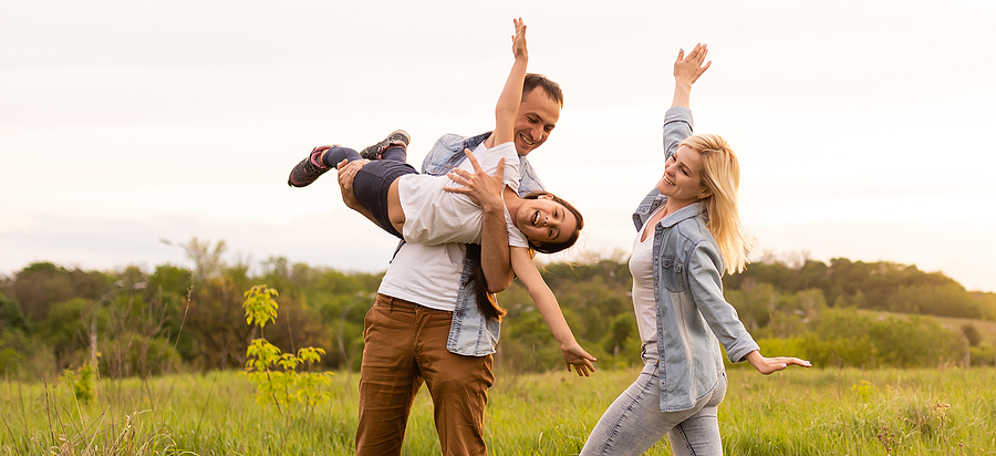 International day of happiness family in field playing flying