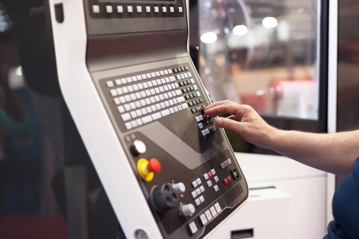 Operator working at programmable machine. CNC machine.