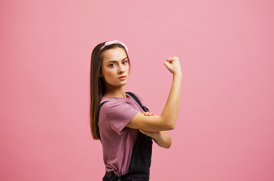 Yes, you can, a strong and independent woman, an image from a poster. The girl shows the biceps. Mother in the Trades