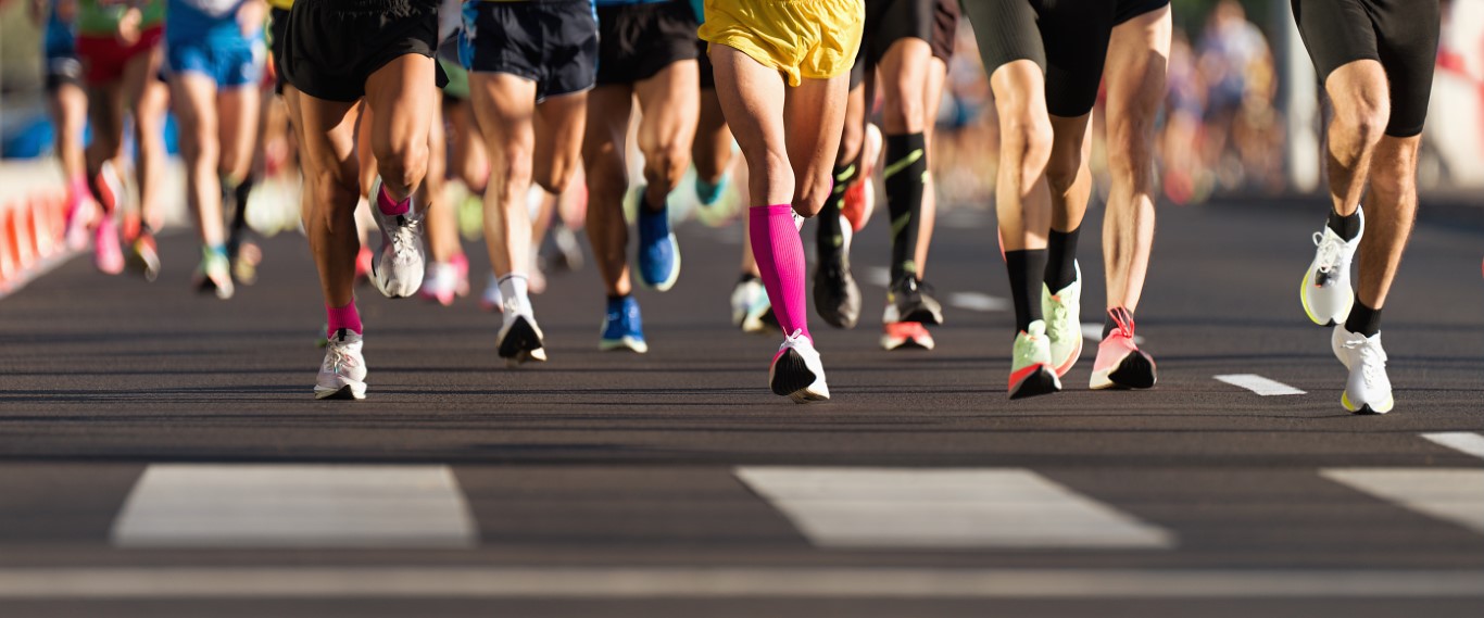 Marathon running race, people feet on city road, runners run urban marathon in the the city