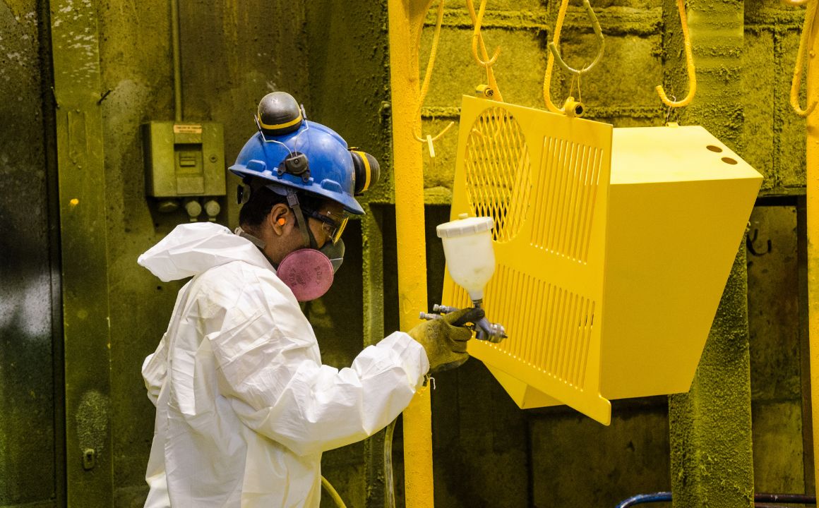 Industrial Painter Charles Y. working on metal components