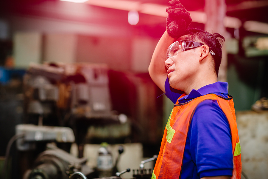 Tired worker, headache hot weather over heat unhealthy engineer working in heavy industry factory.