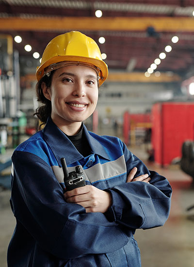 Female machinist in factory helping keep production going