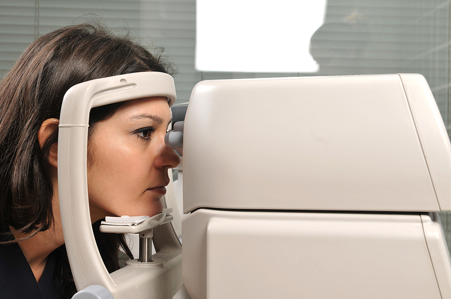 Beautiful young female patient having a medical examination at optician - a series of eye exam related pictures.